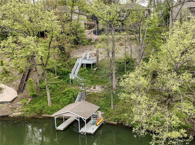 view of dock with stairs, a water view, and boat lift