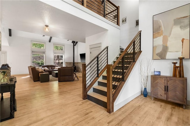 13248 N Old Wire Rd, Rogers, AR 72756 - stairs with wood finished floors, baseboards, and a high ceiling
