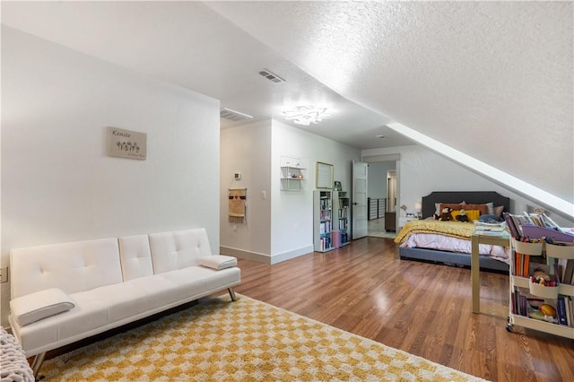 13248 N Old Wire Rd, Rogers, AR 72756 - bedroom with wood finished floors, a textured ceiling, and baseboards