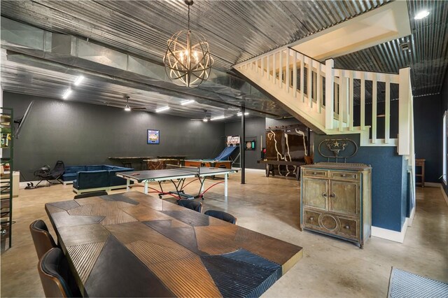 13248 N Old Wire Rd, Rogers, AR 72756 - dining area featuring concrete floors, a chandelier, and baseboards