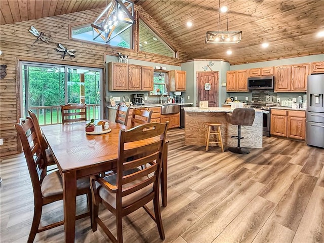 dining room with recessed lighting, light wood-style flooring, wood ceiling, and high vaulted ceiling