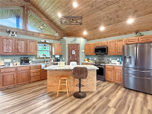 kitchen with wooden ceiling, appliances with stainless steel finishes, a center island, and light wood-type flooring