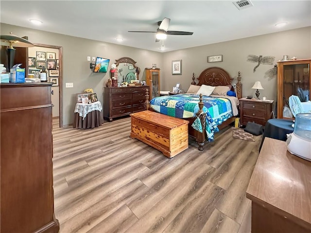 bedroom featuring ceiling fan, light wood-type flooring, and visible vents