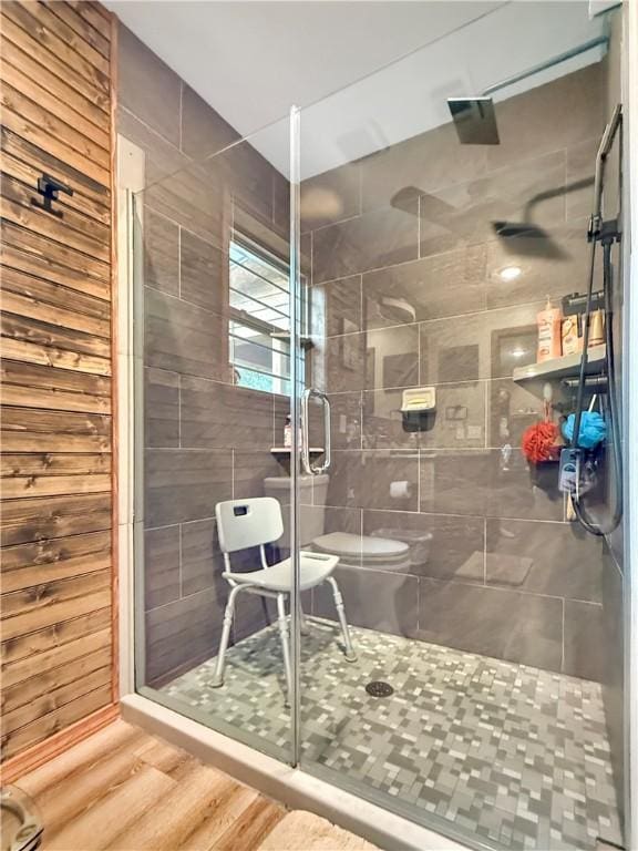 full bathroom with wood finished floors, toilet, and a shower stall