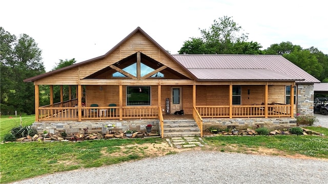log cabin featuring a porch and metal roof