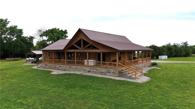 rear view of property featuring an outdoor structure, a lawn, a shed, metal roof, and a porch