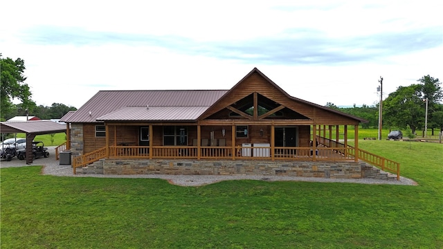 rear view of property featuring a carport, cooling unit, a lawn, covered porch, and metal roof