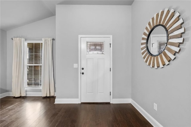 foyer with baseboards, wood finished floors, and lofted ceiling