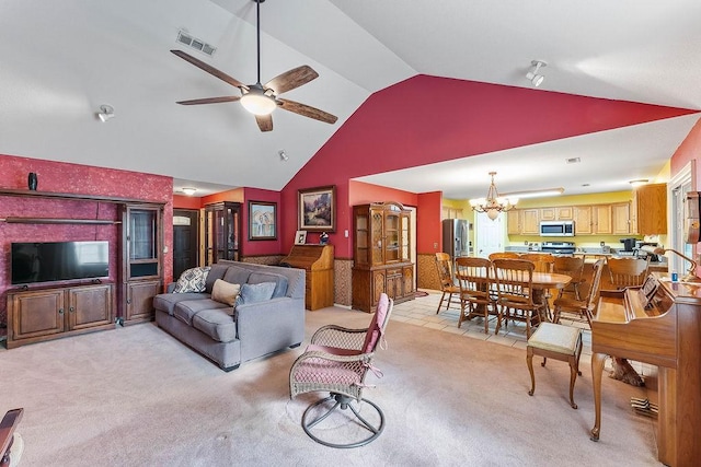 living room featuring high vaulted ceiling, visible vents, light carpet, and ceiling fan with notable chandelier