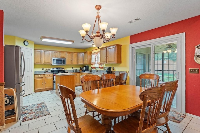 dining area featuring an inviting chandelier, light tile patterned floors, a textured ceiling, and visible vents