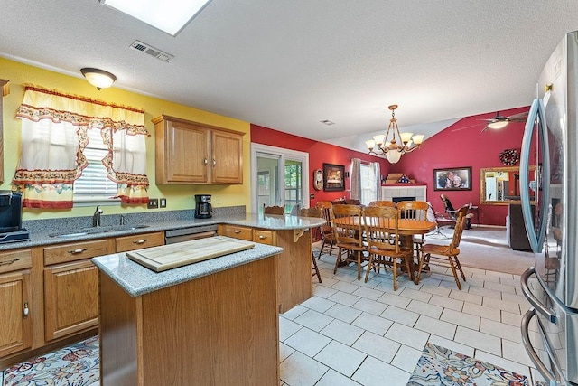 kitchen featuring a sink, appliances with stainless steel finishes, a healthy amount of sunlight, and a peninsula