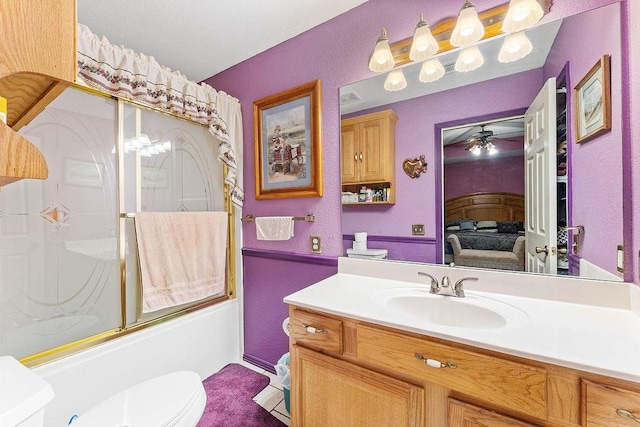 full bathroom featuring vanity, toilet, connected bathroom, a ceiling fan, and enclosed tub / shower combo