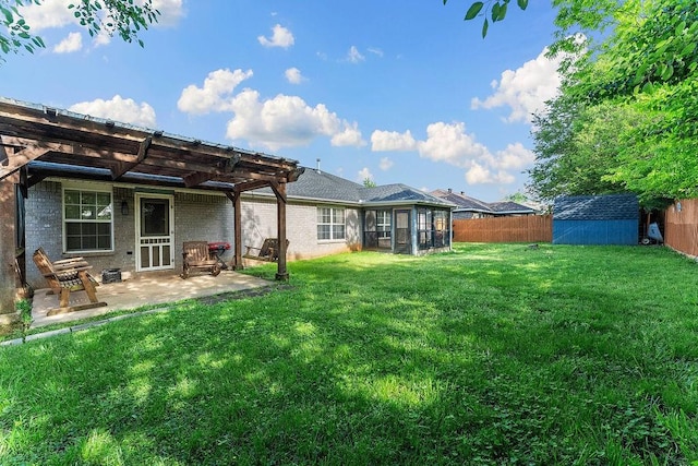 back of property with a lawn, a storage shed, a patio area, a fenced backyard, and a pergola