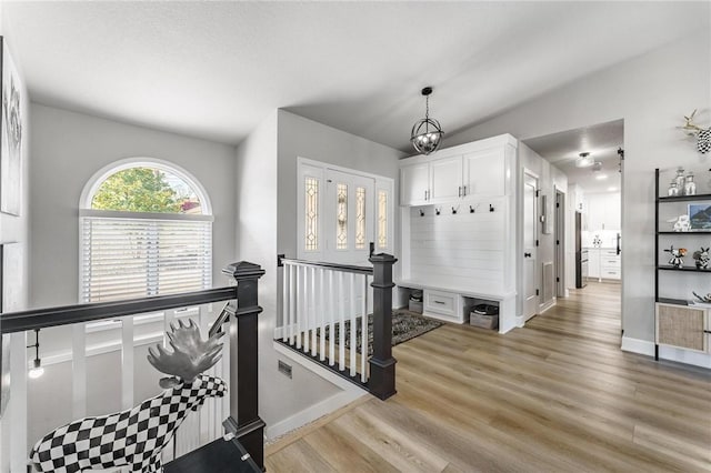 interior space with baseboards, visible vents, and wood finished floors