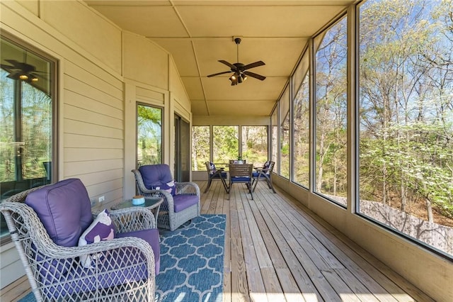 sunroom with plenty of natural light and ceiling fan