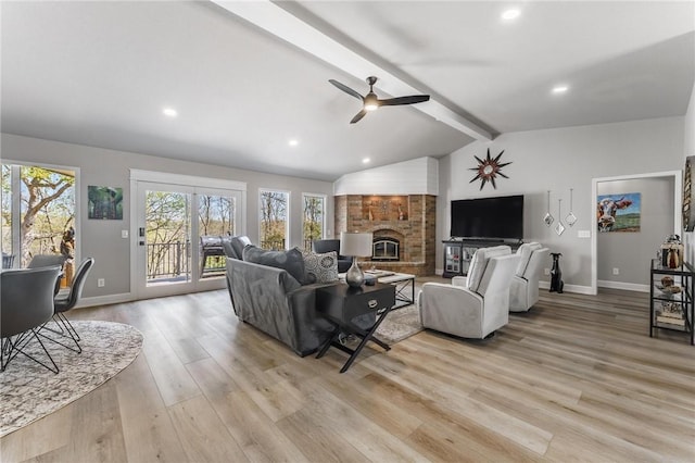 living room featuring baseboards, ceiling fan, vaulted ceiling with beams, and light wood finished floors