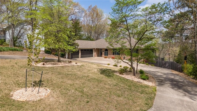ranch-style home with concrete driveway, fence, a front lawn, and a garage