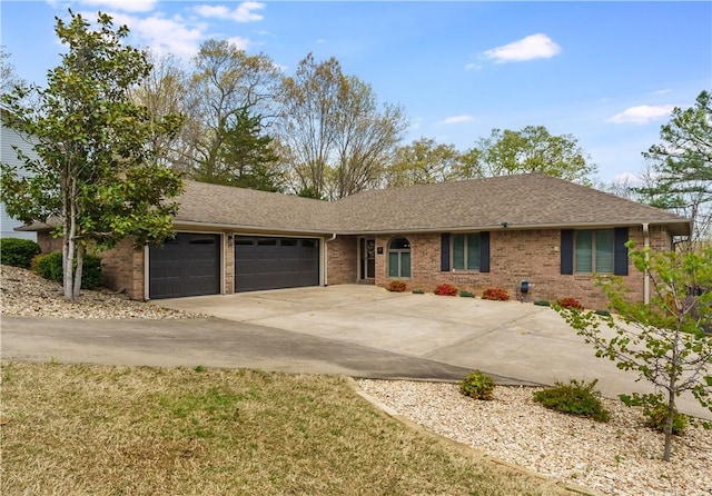ranch-style house with brick siding, an attached garage, driveway, and a shingled roof