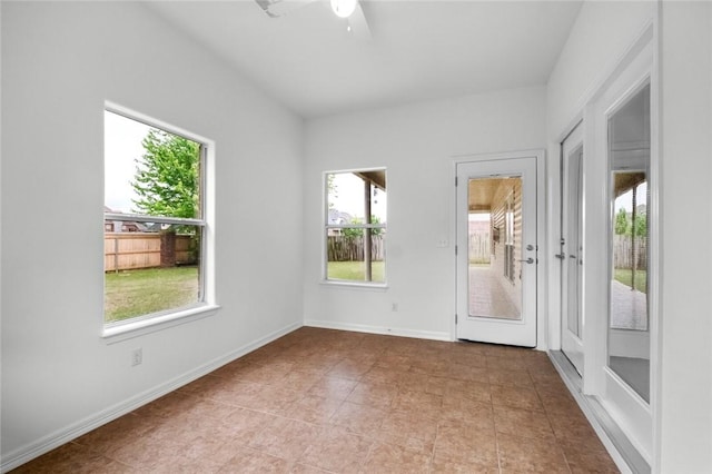empty room featuring light tile patterned flooring and ceiling fan