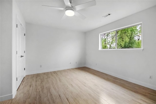 unfurnished room featuring visible vents, a ceiling fan, light wood-style flooring, and baseboards