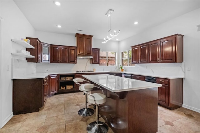 kitchen with open shelves, light countertops, decorative light fixtures, a kitchen island, and under cabinet range hood