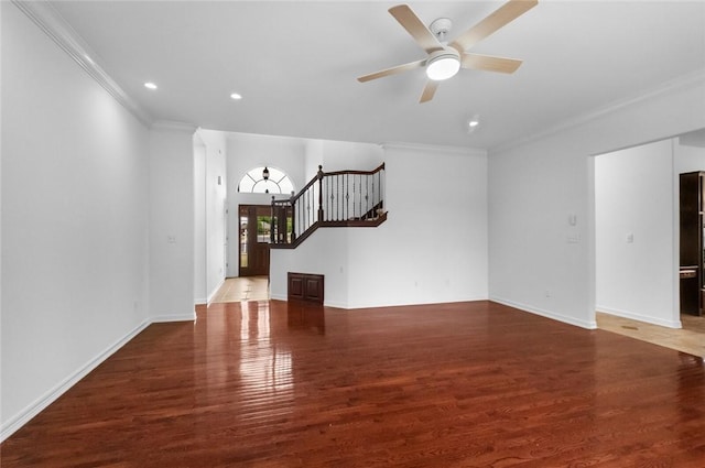 unfurnished living room featuring ceiling fan, ornamental molding, stairs, and wood finished floors