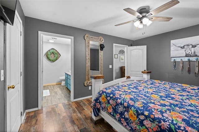 bedroom featuring baseboards, a ceiling fan, ensuite bath, and dark wood-style floors