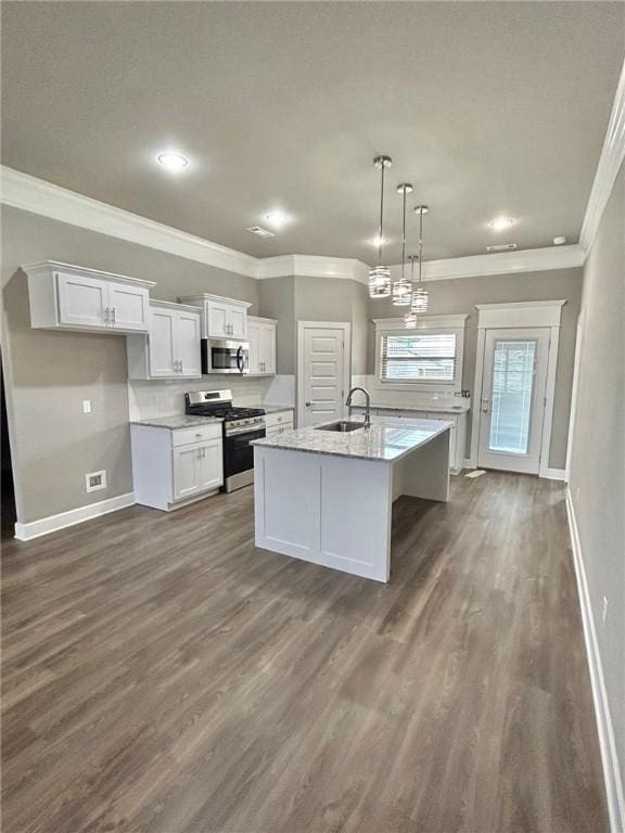 kitchen featuring ornamental molding, white cabinets, a sink, dark wood finished floors, and appliances with stainless steel finishes