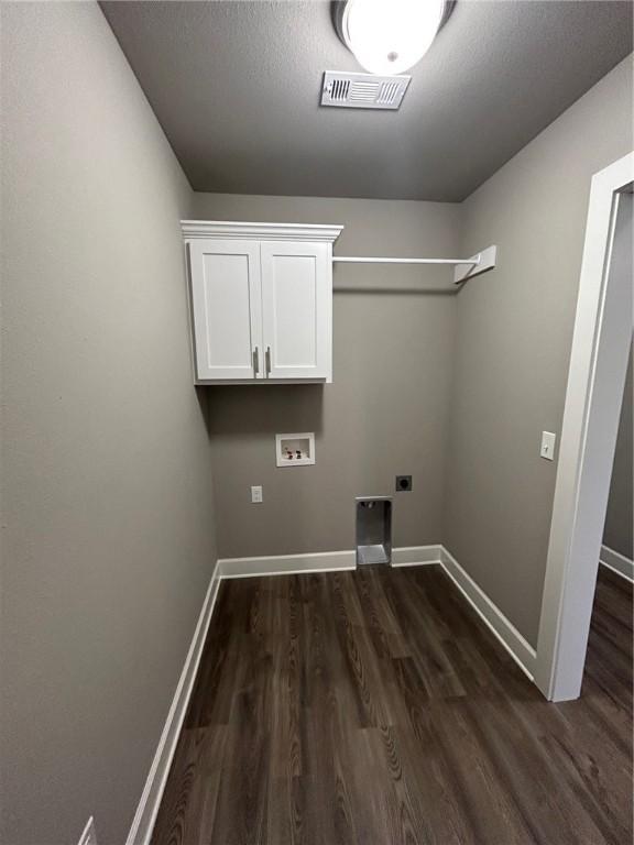 laundry room with electric dryer hookup, visible vents, dark wood-style floors, and hookup for a washing machine