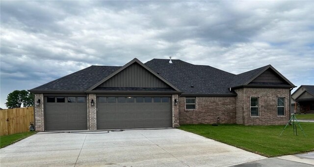 view of front of house featuring brick siding, a garage, board and batten siding, and driveway