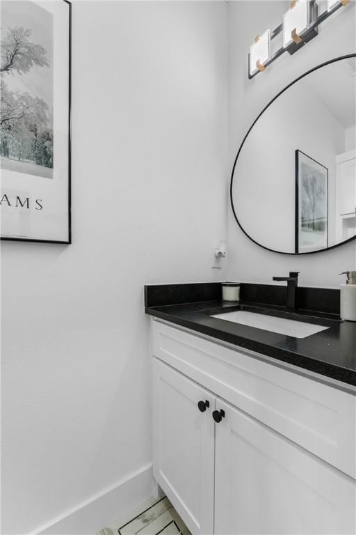 bathroom with vanity and baseboards