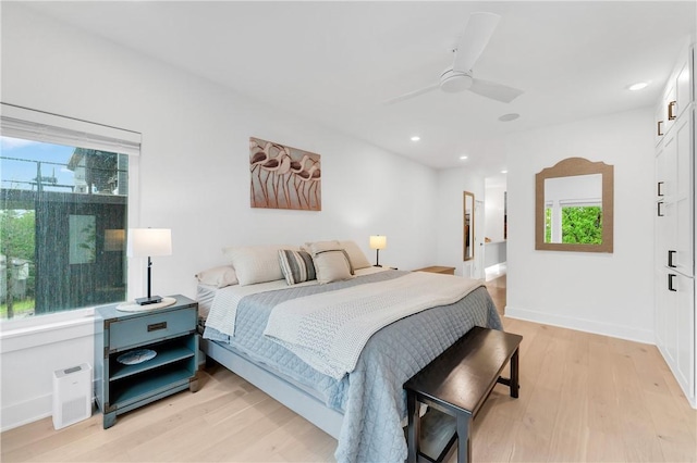 bedroom featuring recessed lighting, multiple windows, and light wood finished floors