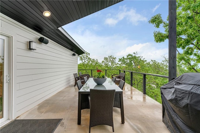 view of patio / terrace with outdoor dining area, a balcony, and grilling area