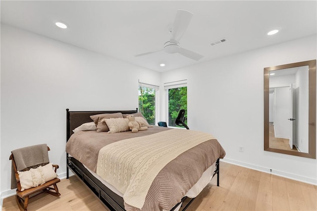bedroom featuring visible vents, baseboards, ceiling fan, and light wood-type flooring