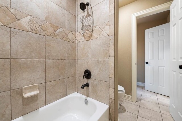 bathroom with tile patterned flooring, shower / tub combination, and toilet