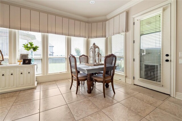 dining area featuring crown molding, light tile patterned floors, and a healthy amount of sunlight