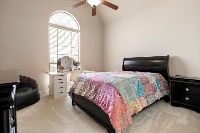 bedroom featuring ceiling fan, light carpet, and lofted ceiling