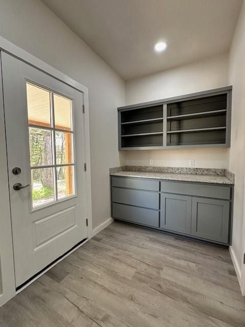 doorway to outside with light wood-style floors, recessed lighting, and baseboards