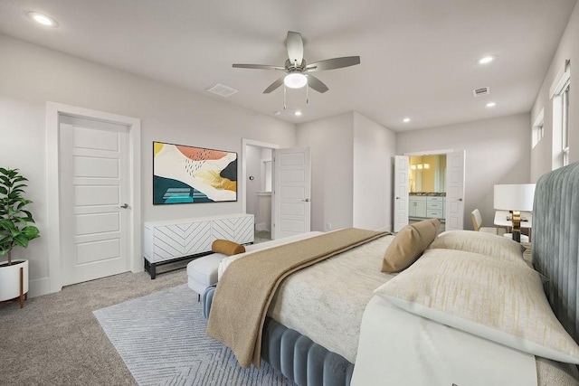 carpeted bedroom with ensuite bathroom, recessed lighting, and visible vents