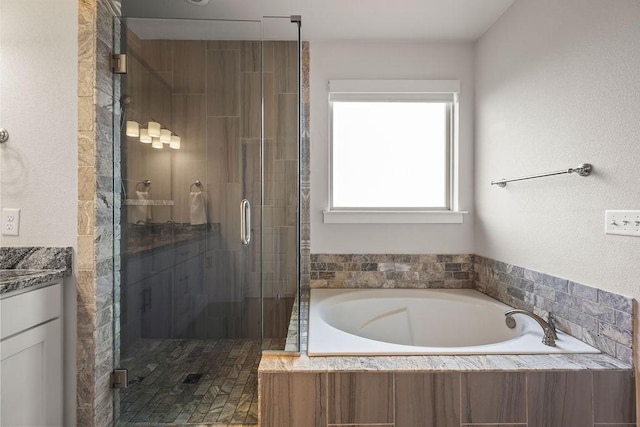 bathroom featuring vanity, a garden tub, and a stall shower