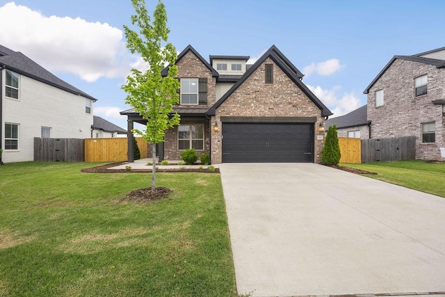view of front of property featuring brick siding, a front lawn, fence, and driveway