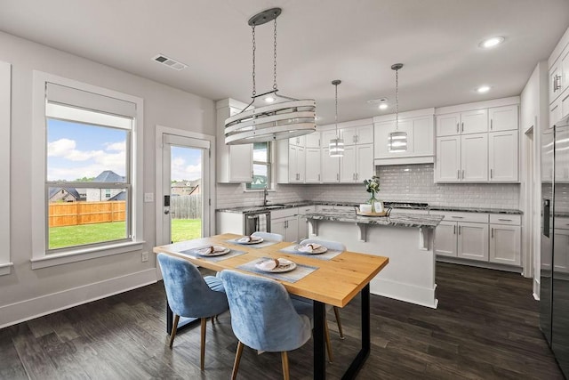 dining area featuring recessed lighting, baseboards, visible vents, and dark wood-type flooring