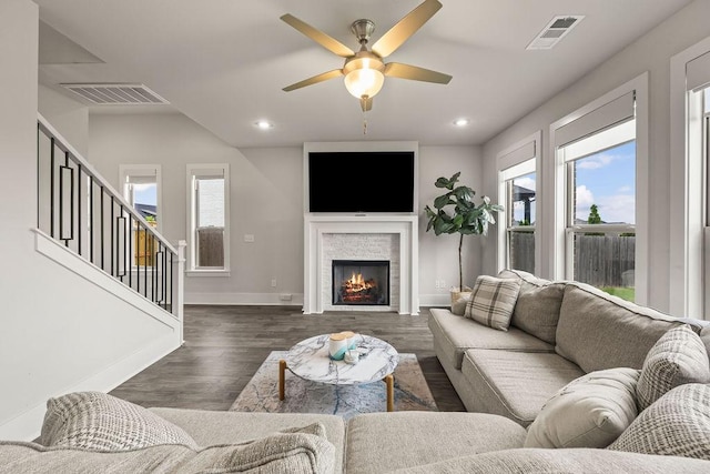 living room with visible vents, ceiling fan, and a healthy amount of sunlight