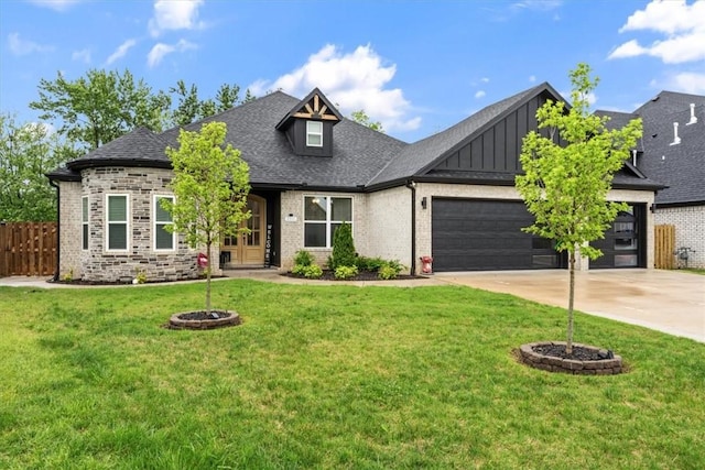 craftsman-style home featuring a front lawn, fence, board and batten siding, an attached garage, and driveway