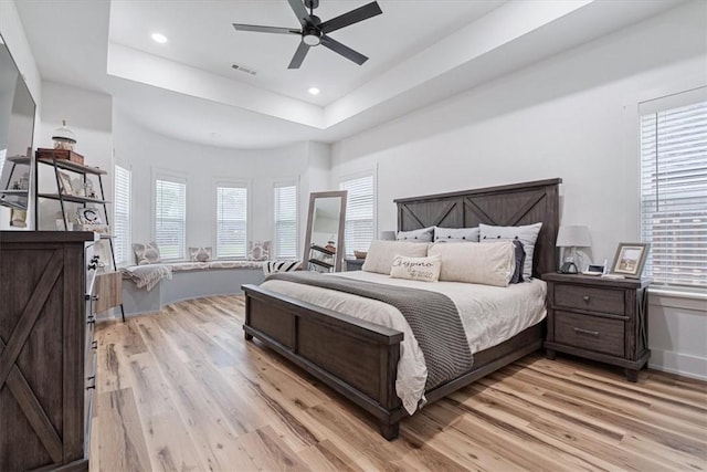 bedroom featuring visible vents, light wood-style flooring, and multiple windows