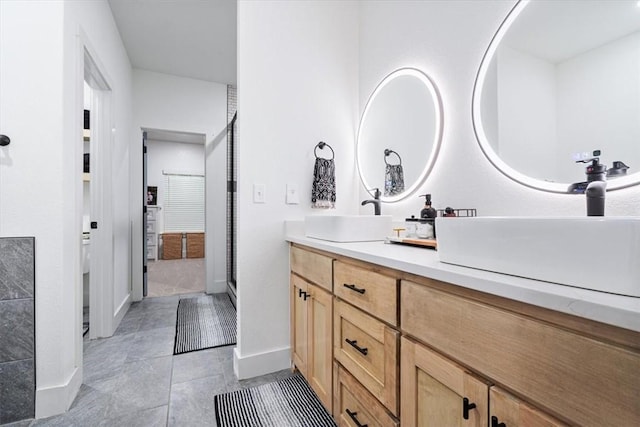 full bathroom with baseboards, a shower stall, vanity, and tile patterned floors