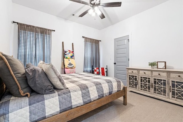 bedroom with ceiling fan, visible vents, and carpet