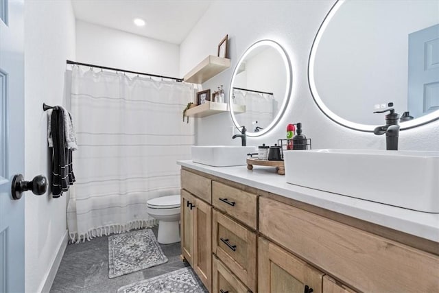 bathroom with double vanity, toilet, a sink, and a shower with curtain