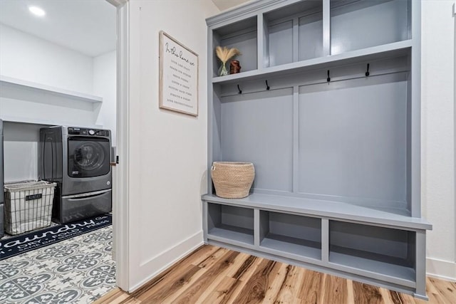 mudroom featuring baseboards, washer / clothes dryer, and wood finished floors