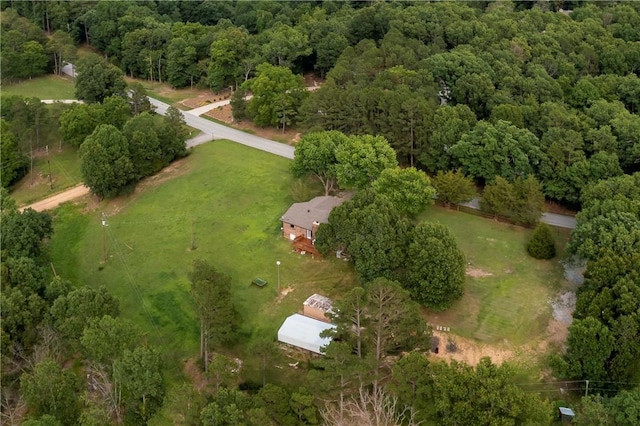 bird's eye view with a wooded view
